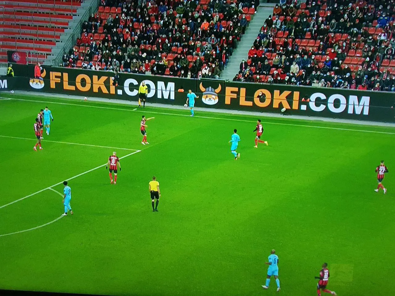 A Floki ad in a football stadium.