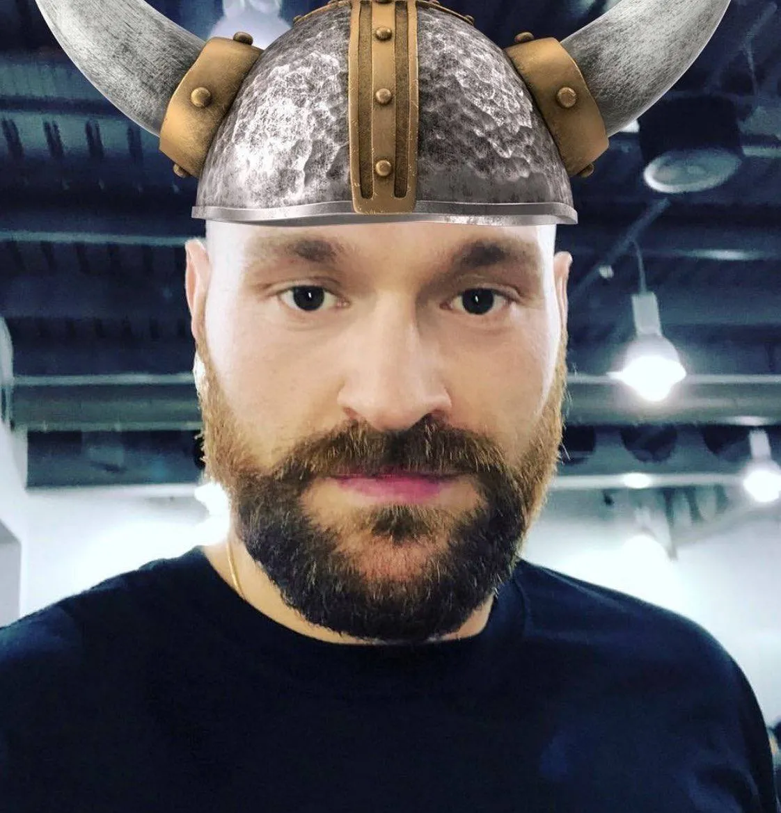 An image of Tyson Fury wearing a viking helmet.